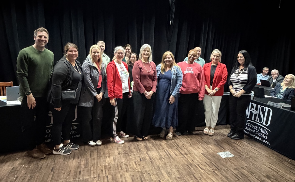 Maddux teachers and administrators pose for a photo with the Board of Education